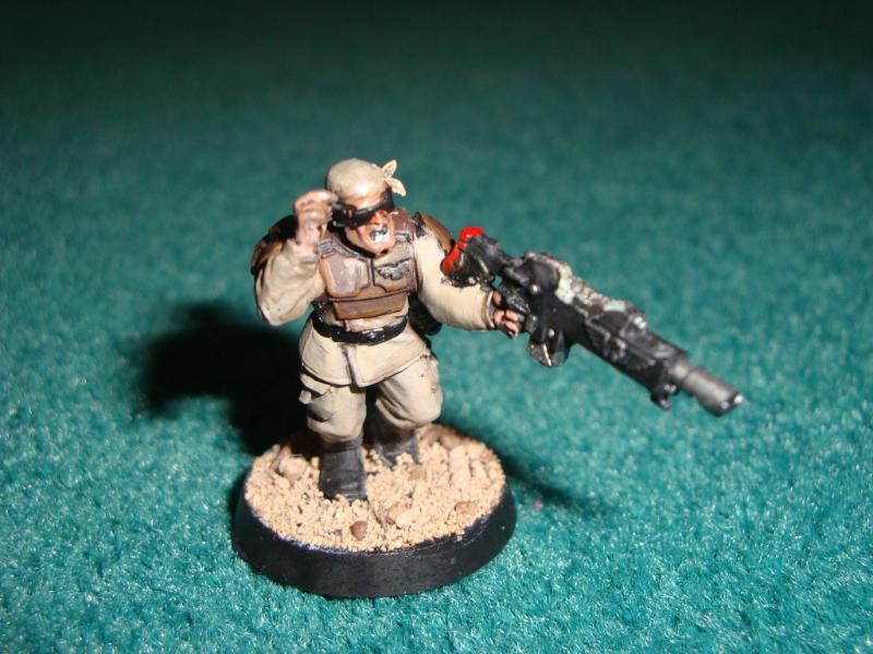 This model has a catachan head with a raised arm from the vox caster its gun is minorly converted to fit the laspistol hand