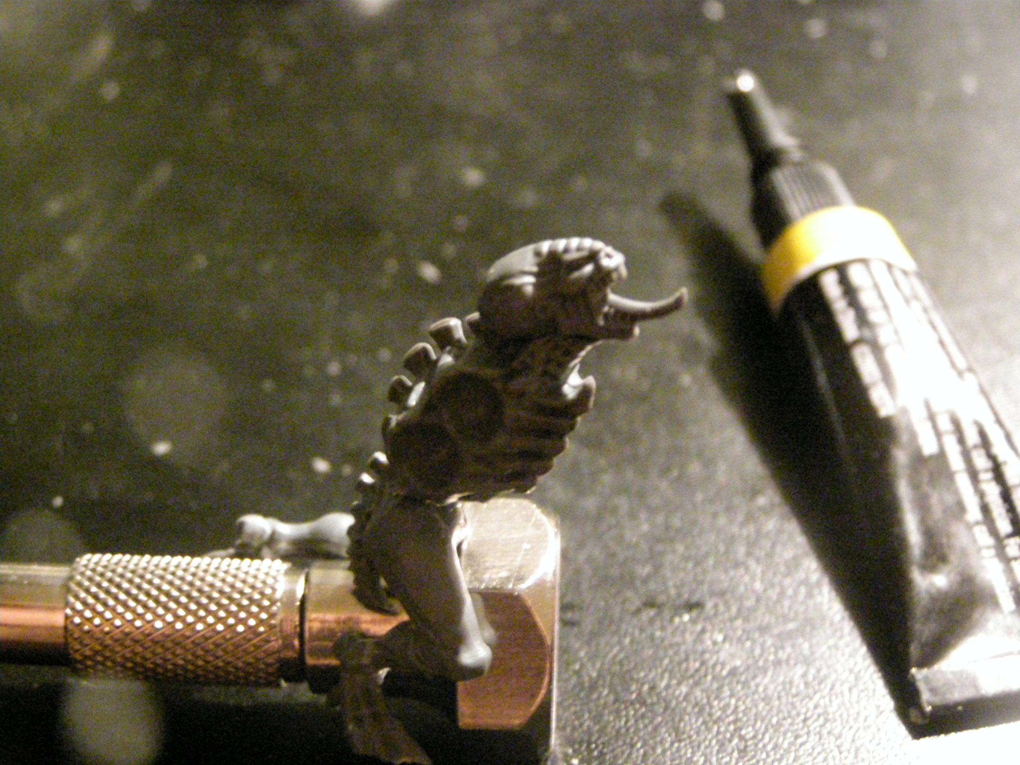 here is the head just glued on If you like it great I did not, so I just make a pin hole at the top of the spine and then at the bottom of te head, and used green stuff to make the neck