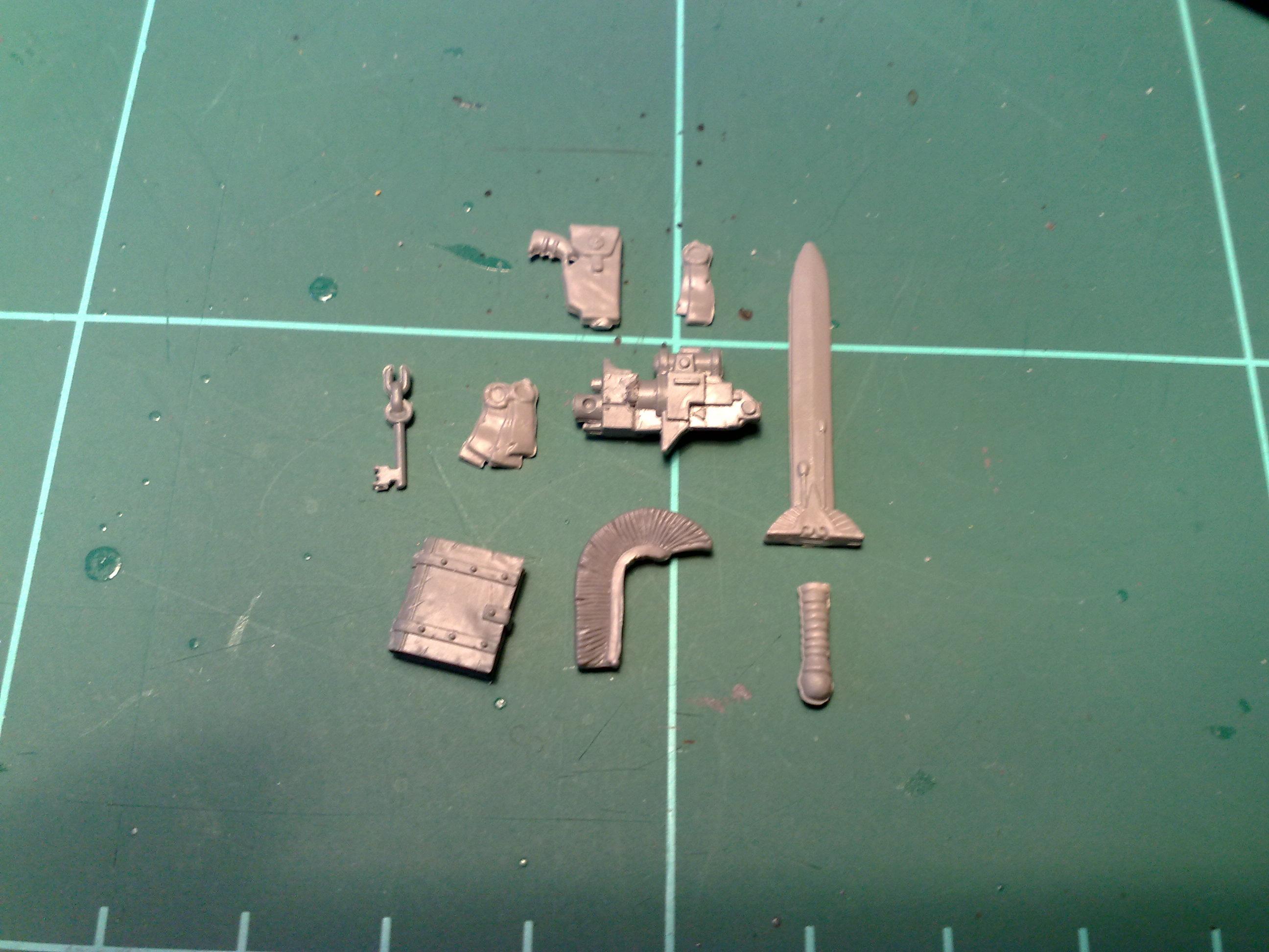 Various equipment. Grimoire, Power sword, purity seals, mane, shouldercannon, pistol and key