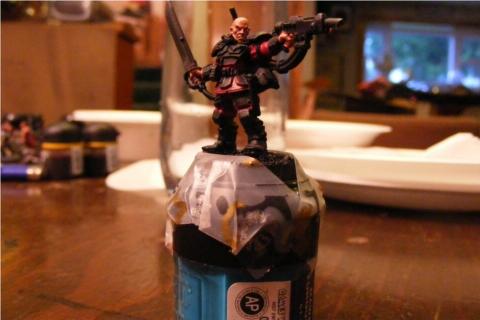 Here I've tape the model to a pot im not using, to hold as I paint