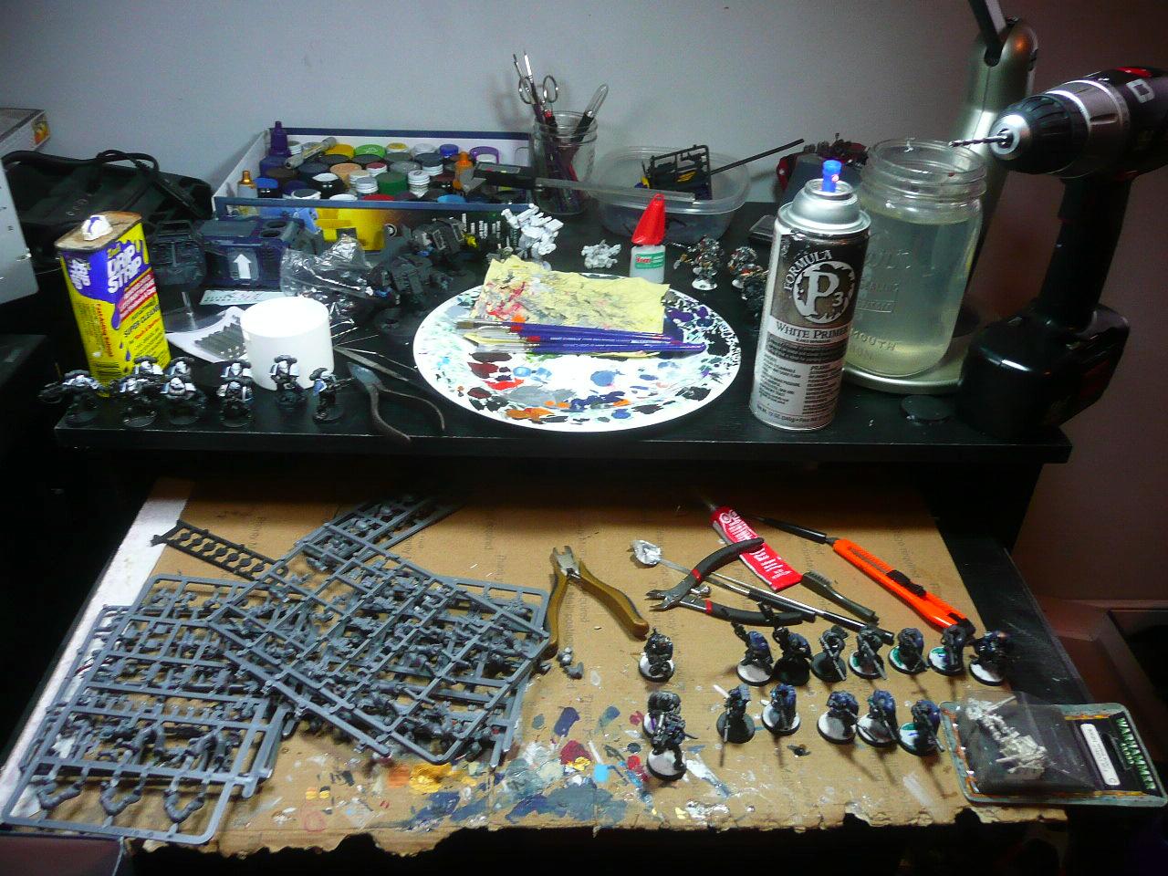 Plate for a palette, mason jar for paint water. Slideaway keyboard shelf is great for this hobby, you can fit a whole land raider under there. There are sternguard veterans, marine scouts, and a few grey knights visible