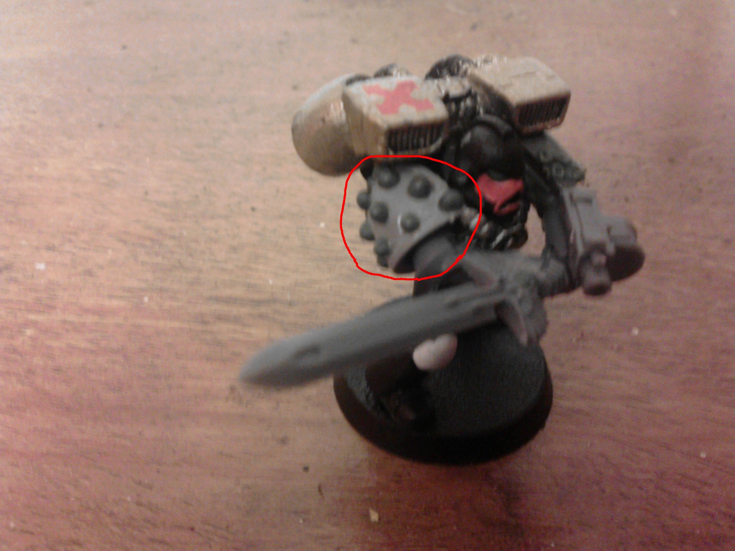 using plastic glue or super glue if your using a metal shoulder pad, start by adding two little drop of glue next to each other but leaving a gap near the top of the shoulder pad and then start to stagger them as shown