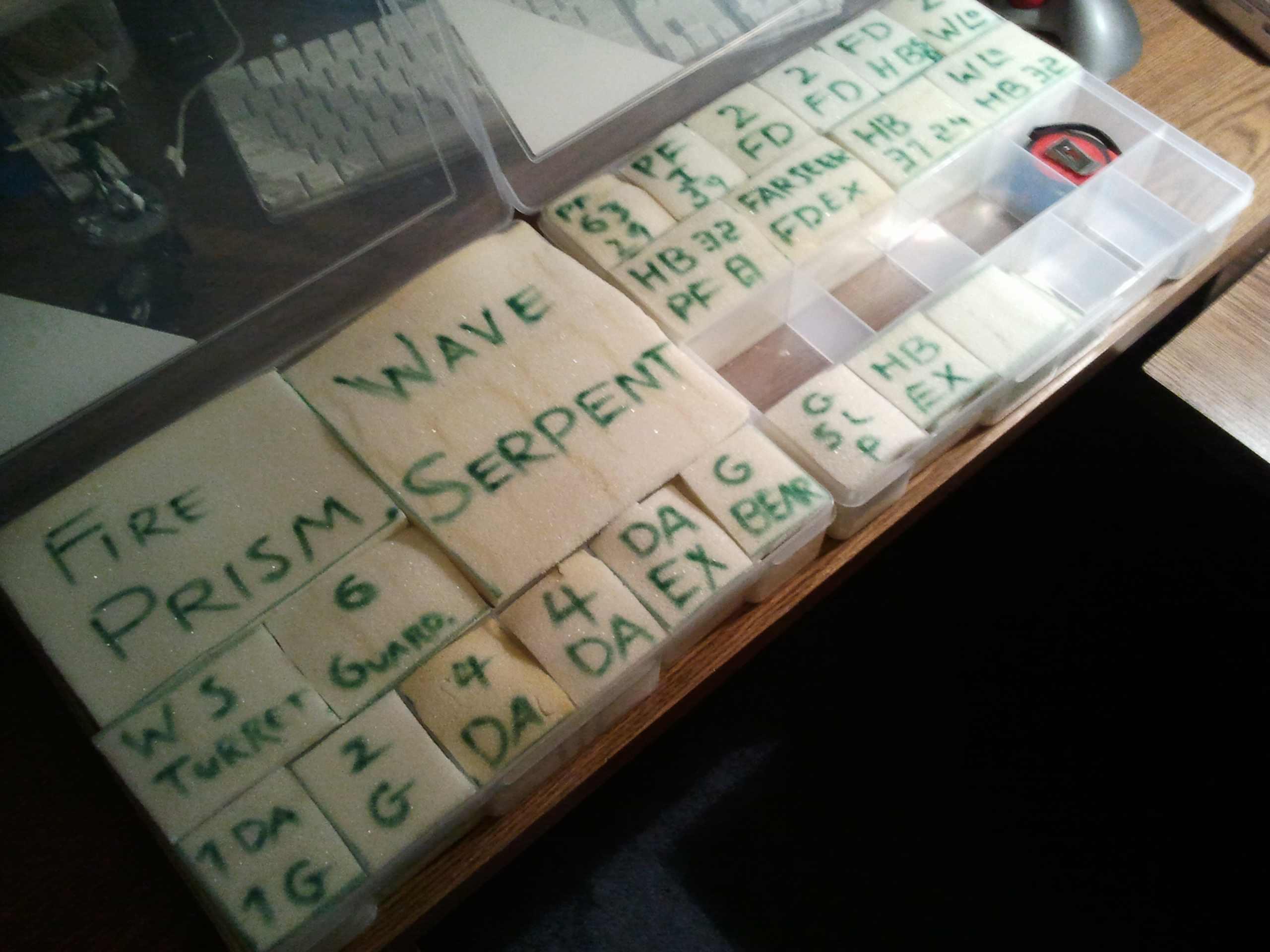 Voila! I put name's and codes on each section to remember which models fit best where. If you compare the two boxes, you'll notice the left has had plastic barriers cut out to make room for tanks. 