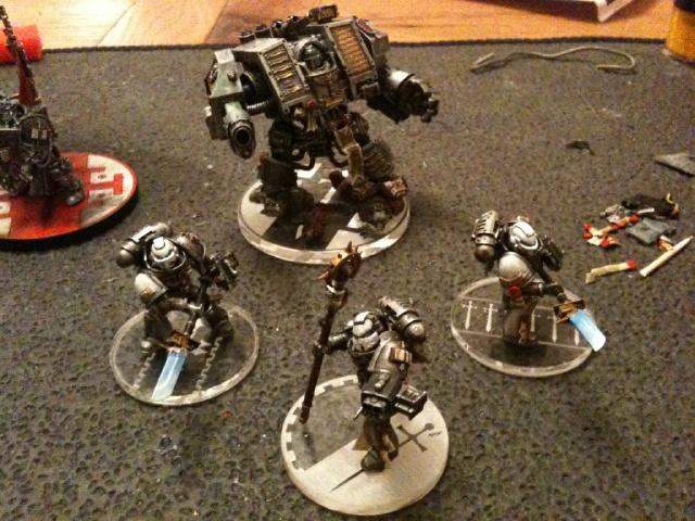 Power-armoured GKs on clear bases. He's into painting and modelling rather than playing so isn't bothered by them being on larger bases