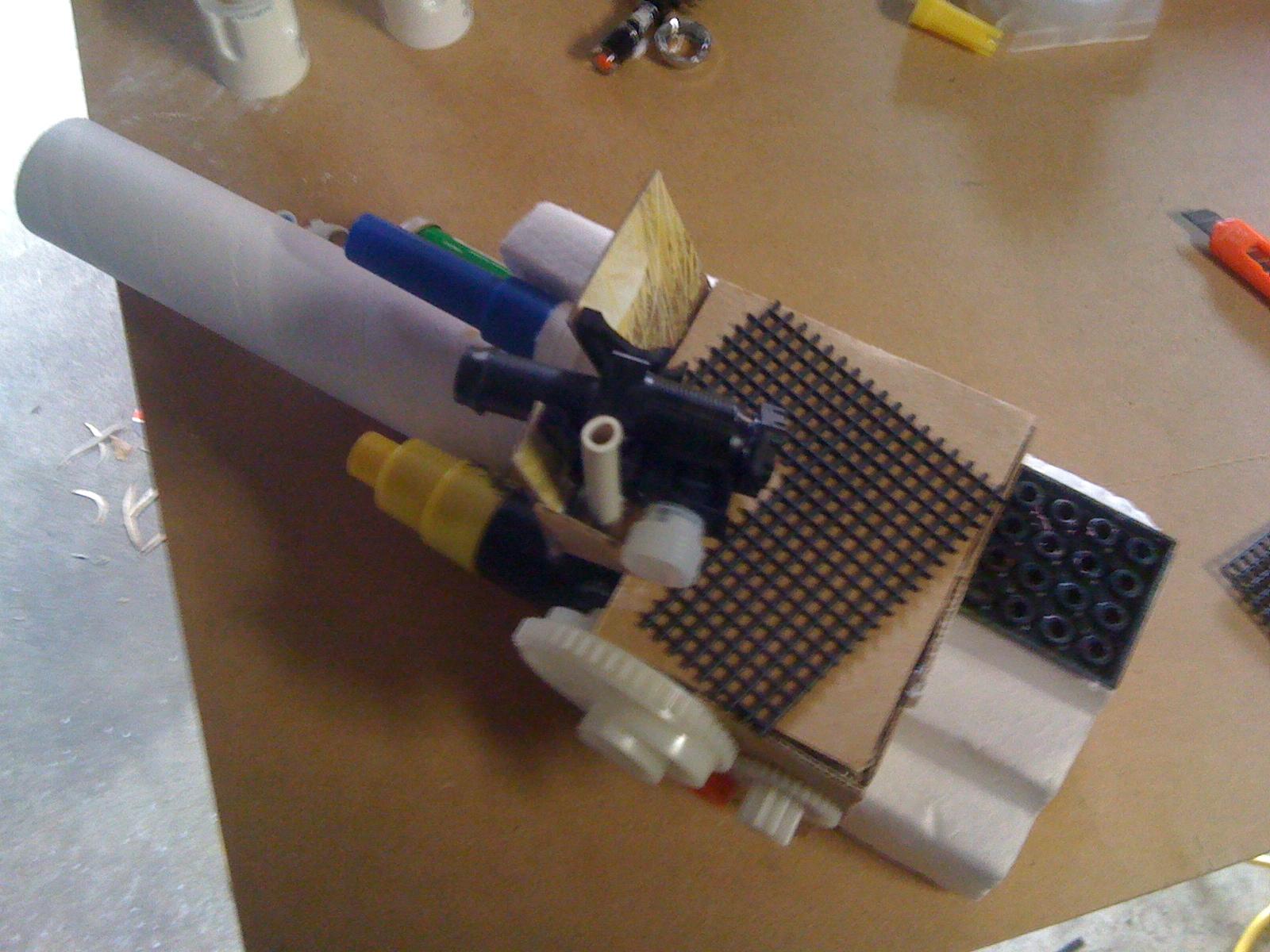 Ahhh there you can see the big gun on the platform. I made it from some sprinkler parts. The grating there was a test piece made from some gardening supplies. I covered the whole flat platform with it and was happy with the final result