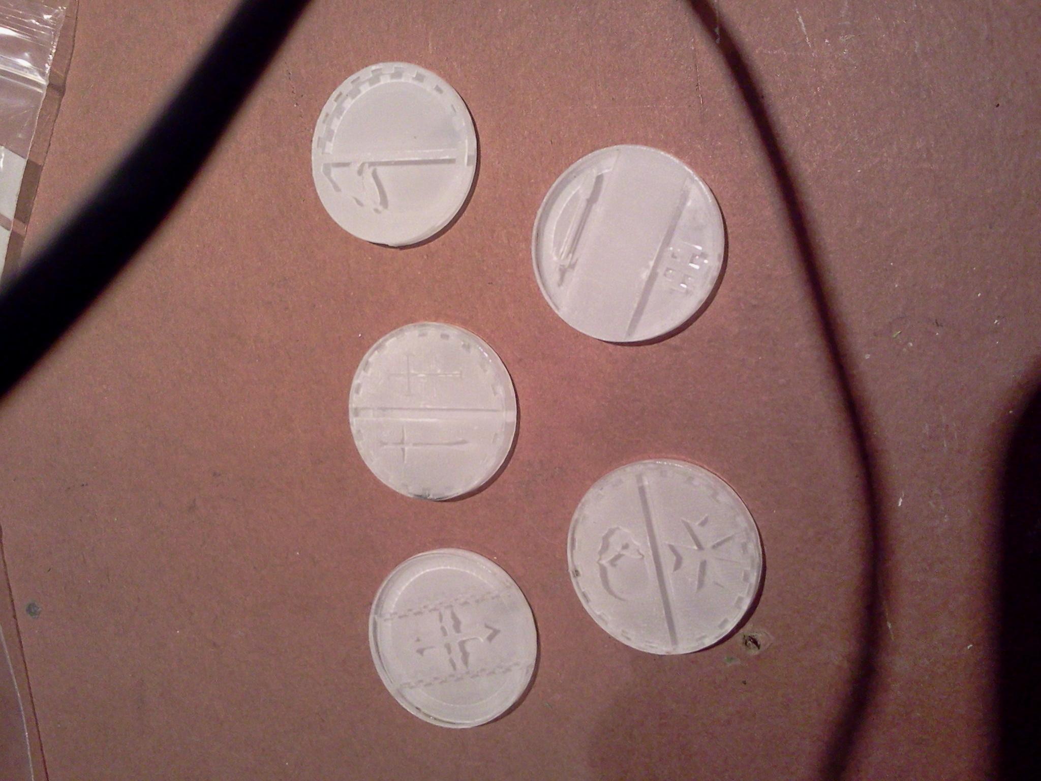 25mm bases with Templar style iconography cut from 3mm acrylic. The protective film is still on the backs so it's a bit hard to see the detail