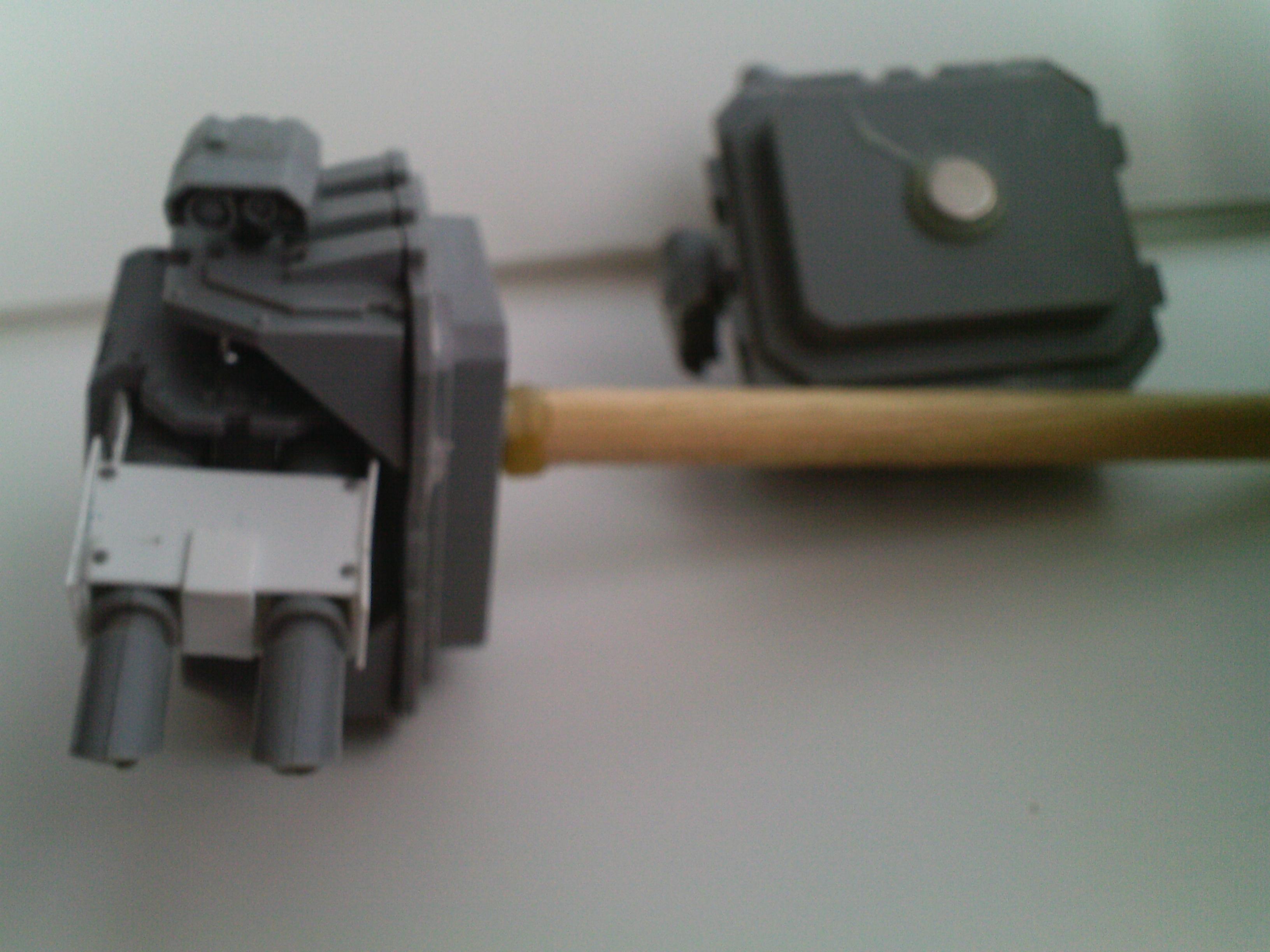 The picture turned out fuzzy. This is just a small dowel with magnets on either end, holding the TL LC in place