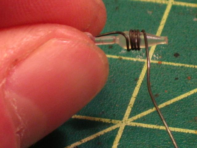 I then start to wrap the wire around a plastic label  fastener 