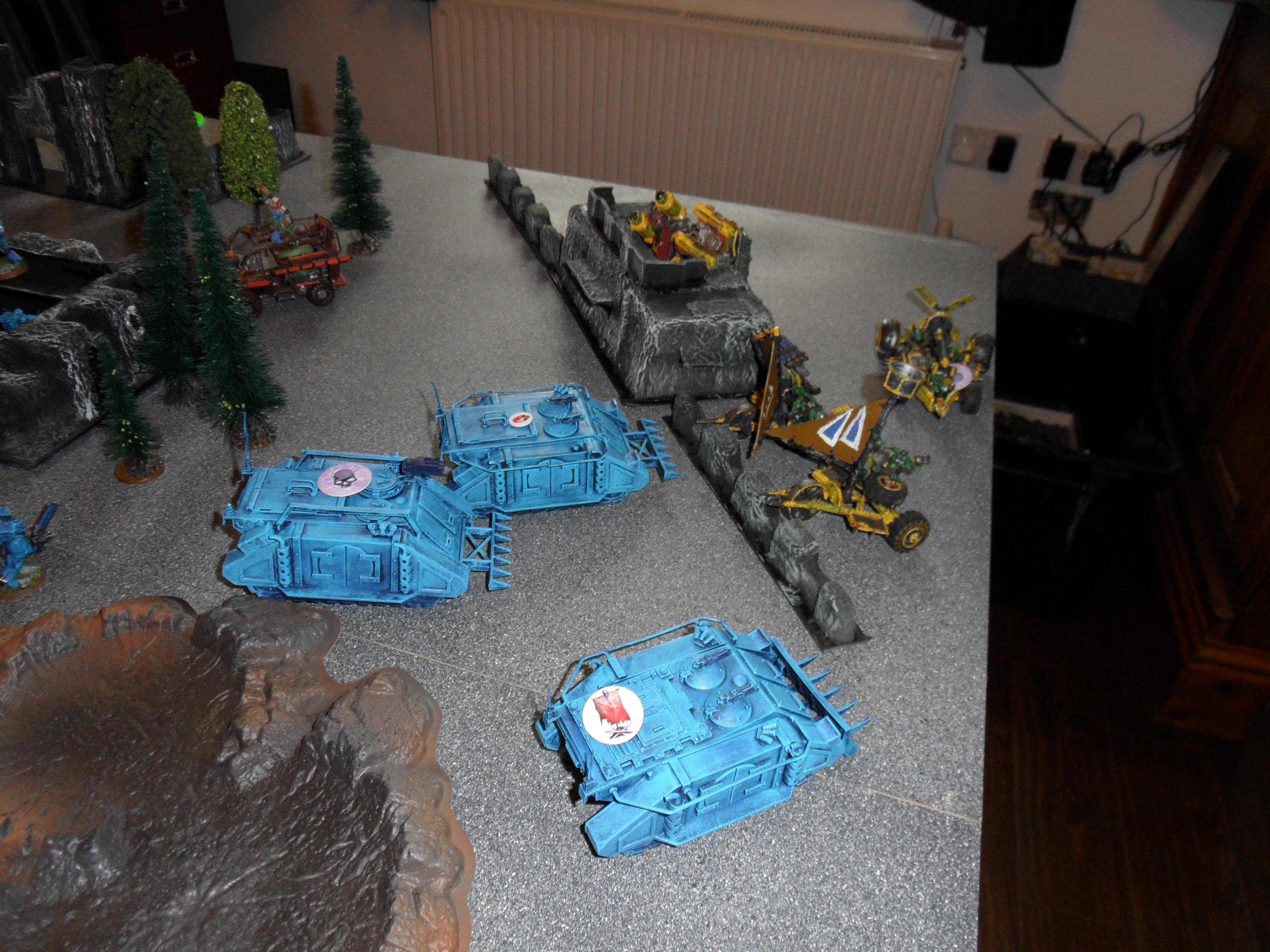 Rhinos battle forward towards the Ork deployment zone with a tactical plan