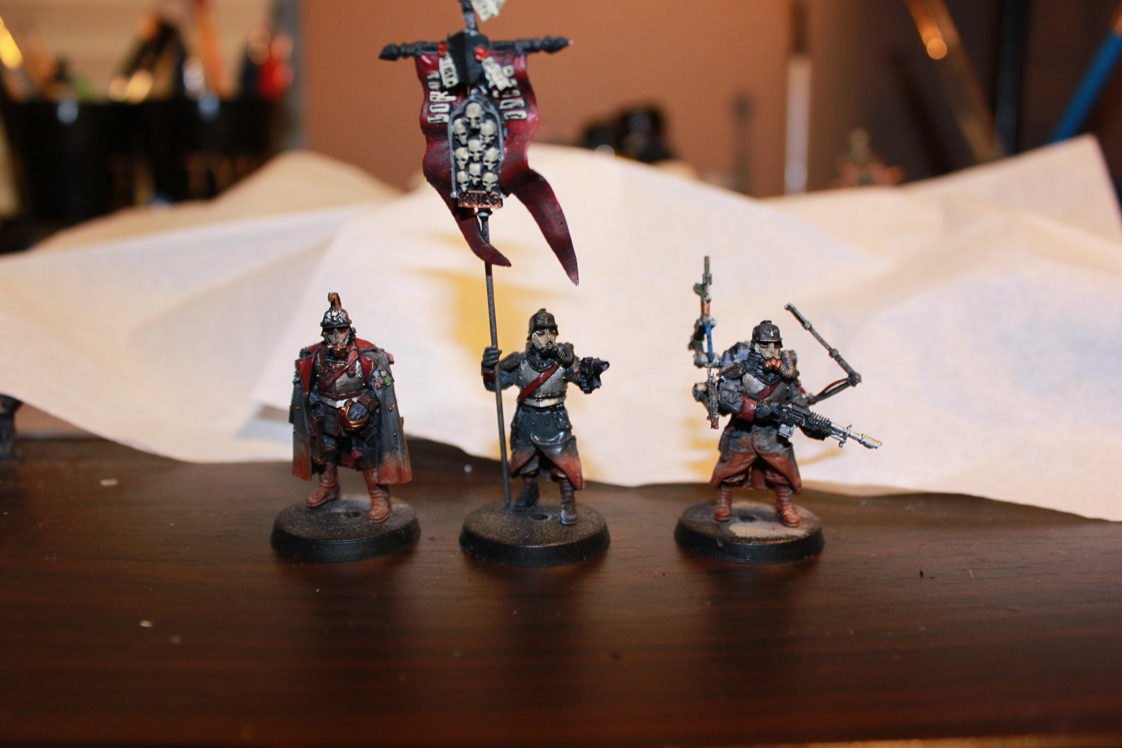 from Left to Right Senior Officer, Standard, Techpriest