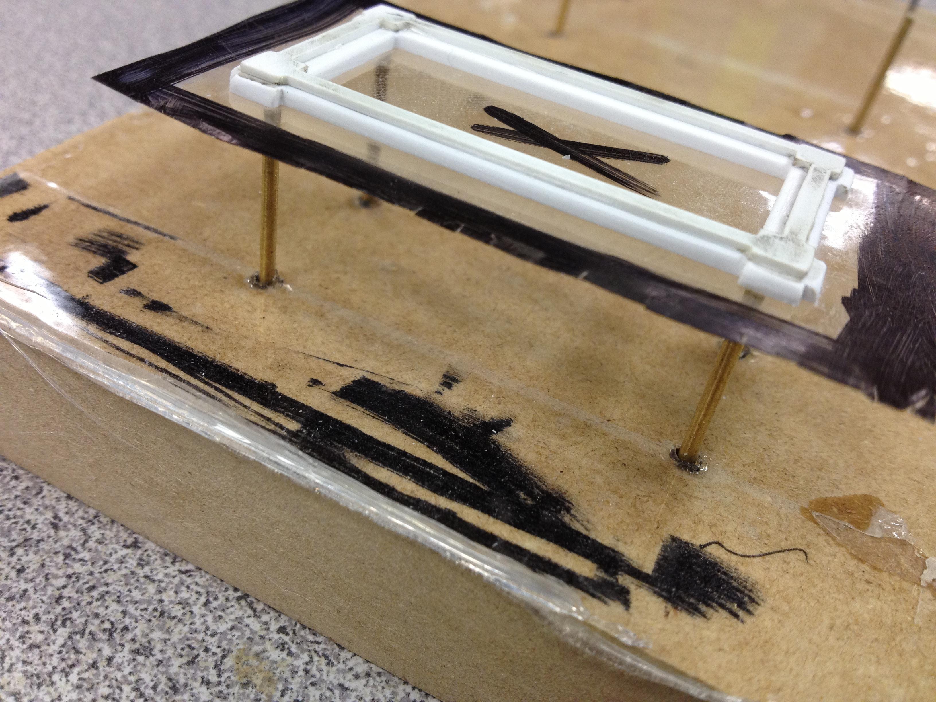 Window with tape parting lines, suspended on brass rods