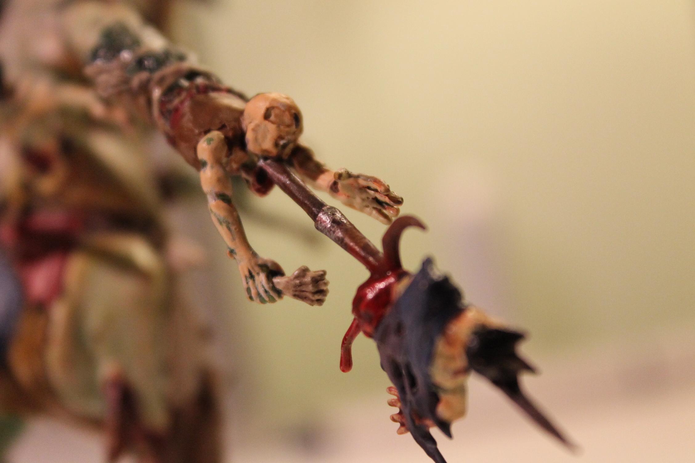 The right hand has been replaced with a zombie to grab and pull people into the spear jutting out it's mouth