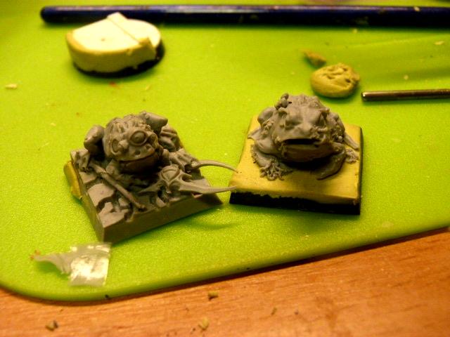 The frogs sitting pretty on their bases