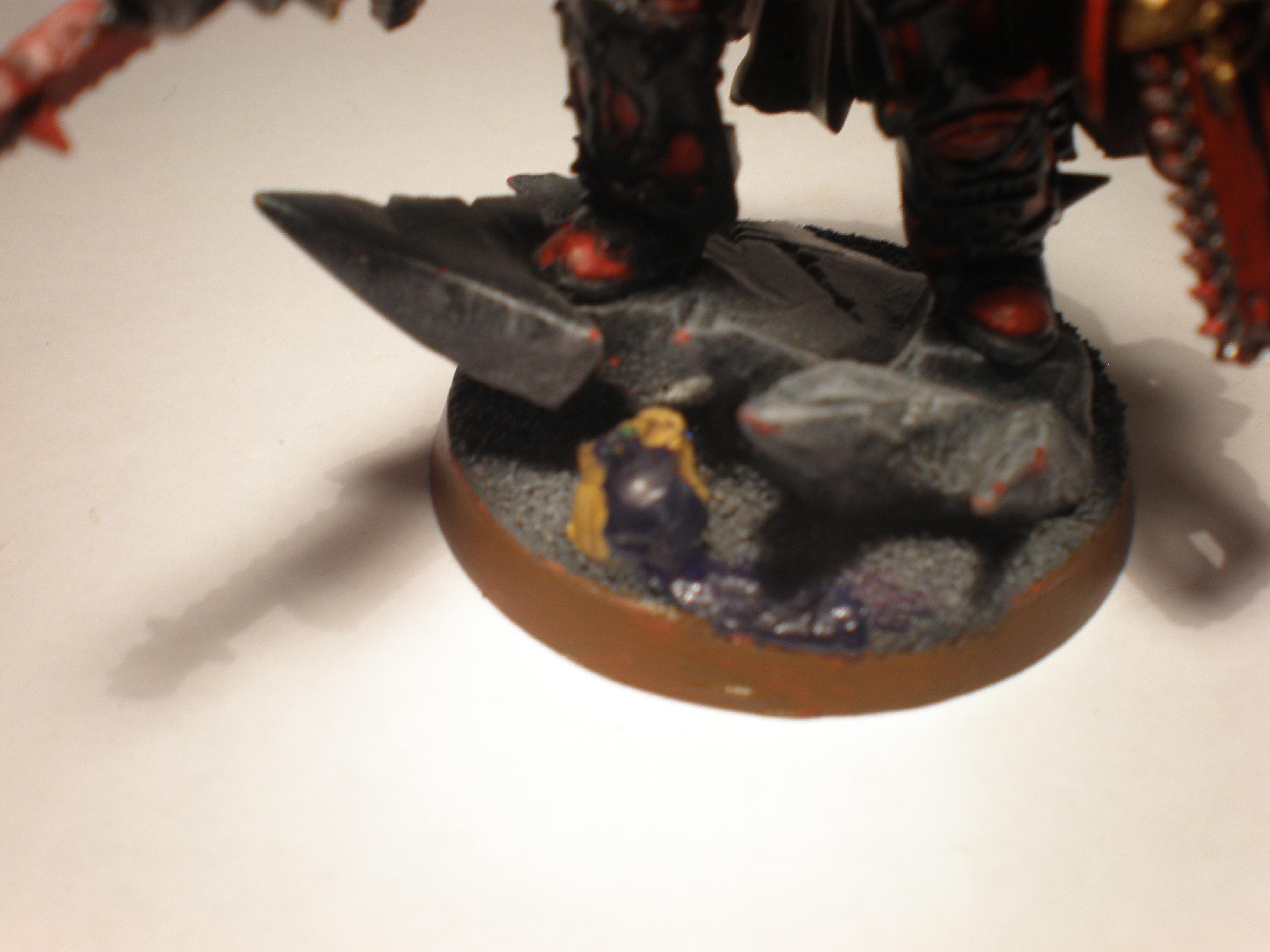 My firend plays Tau so i took a tau head and painted it in his army's colours and added some blood