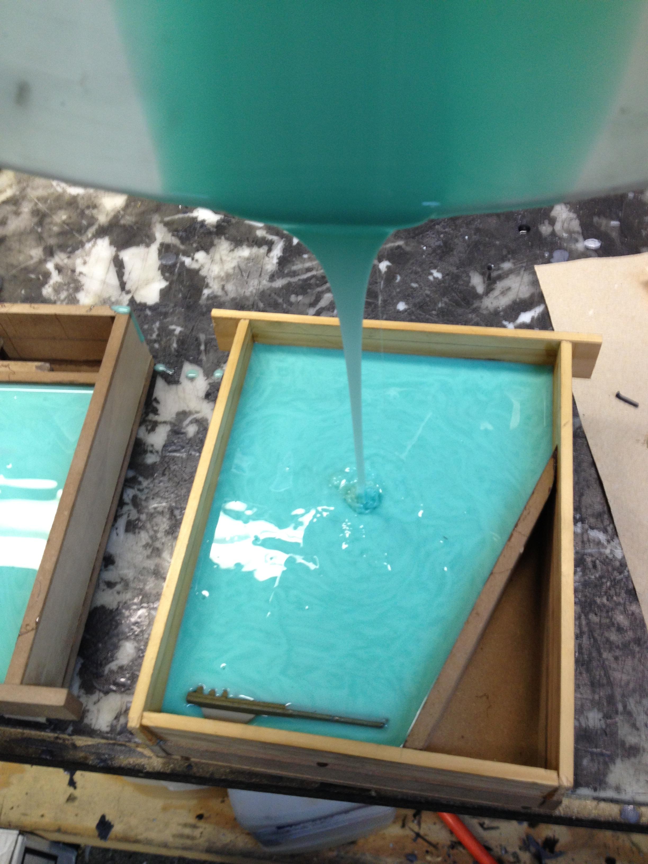 Adding the last of the silicone before closing the molds