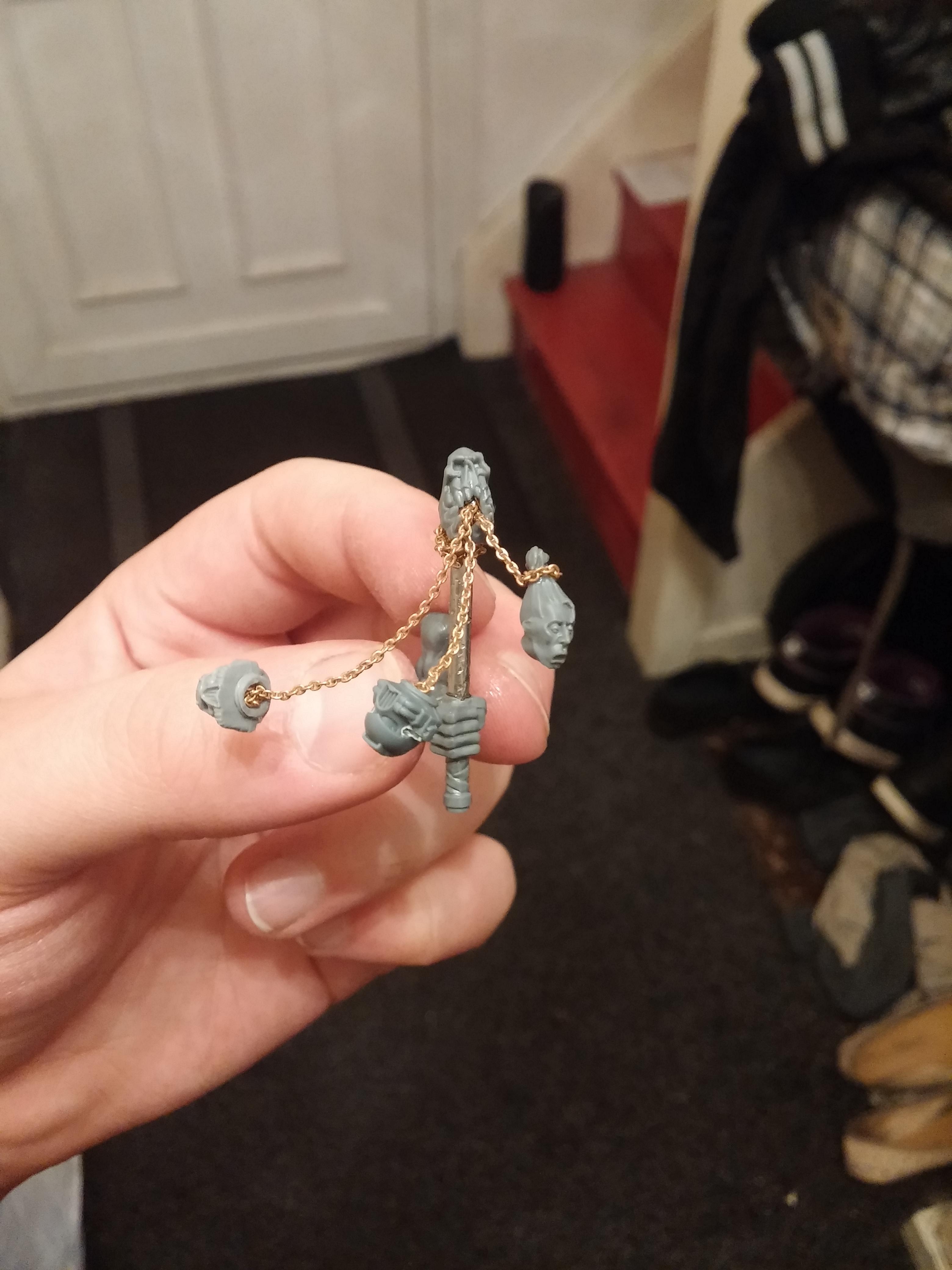 As you can see, I've placed the Ork skull at the top, spewing out the three chained trophy heads