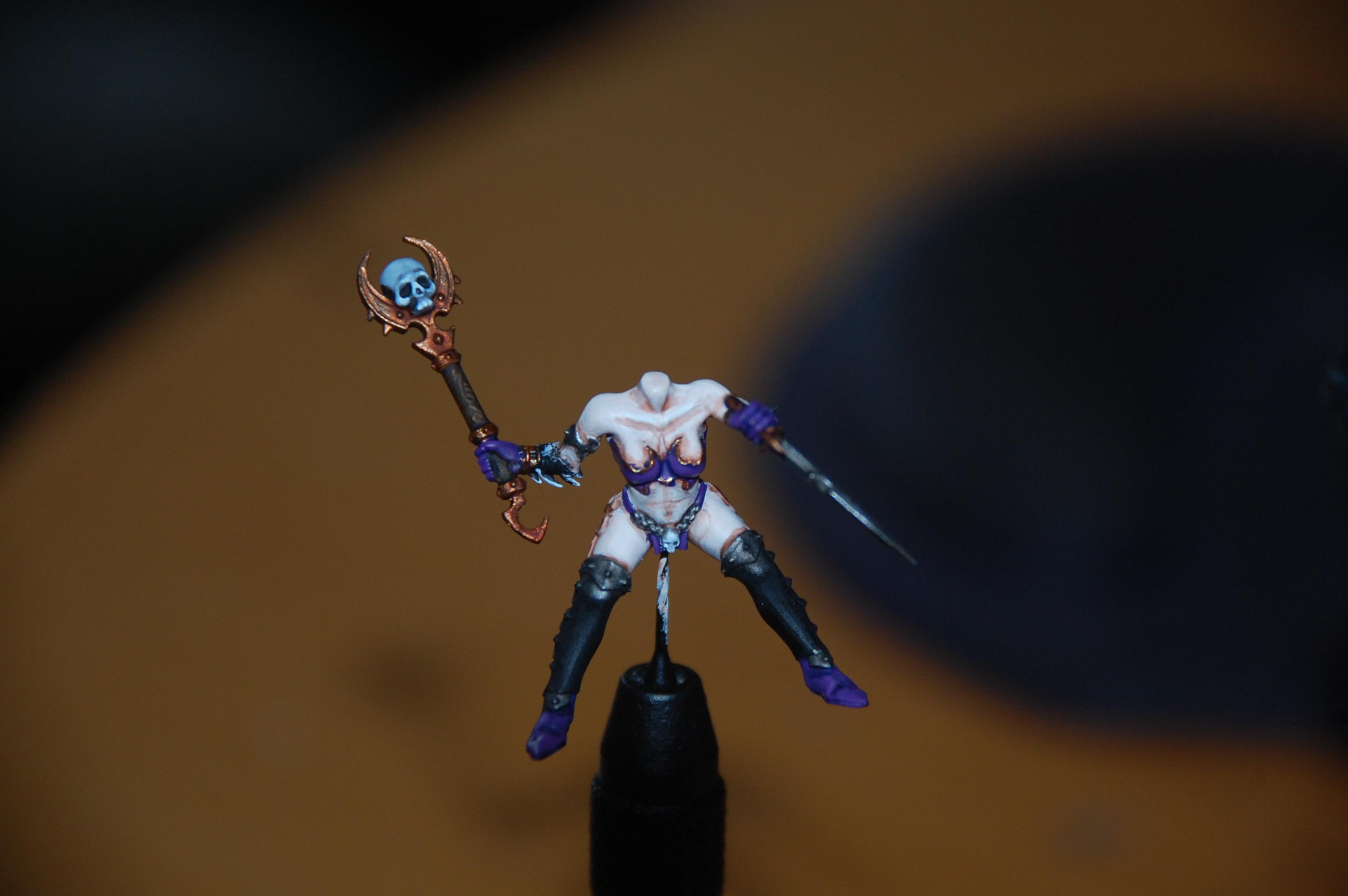 Some more work on the sorceress she now has gold trim arround her armor and painted somemore little details