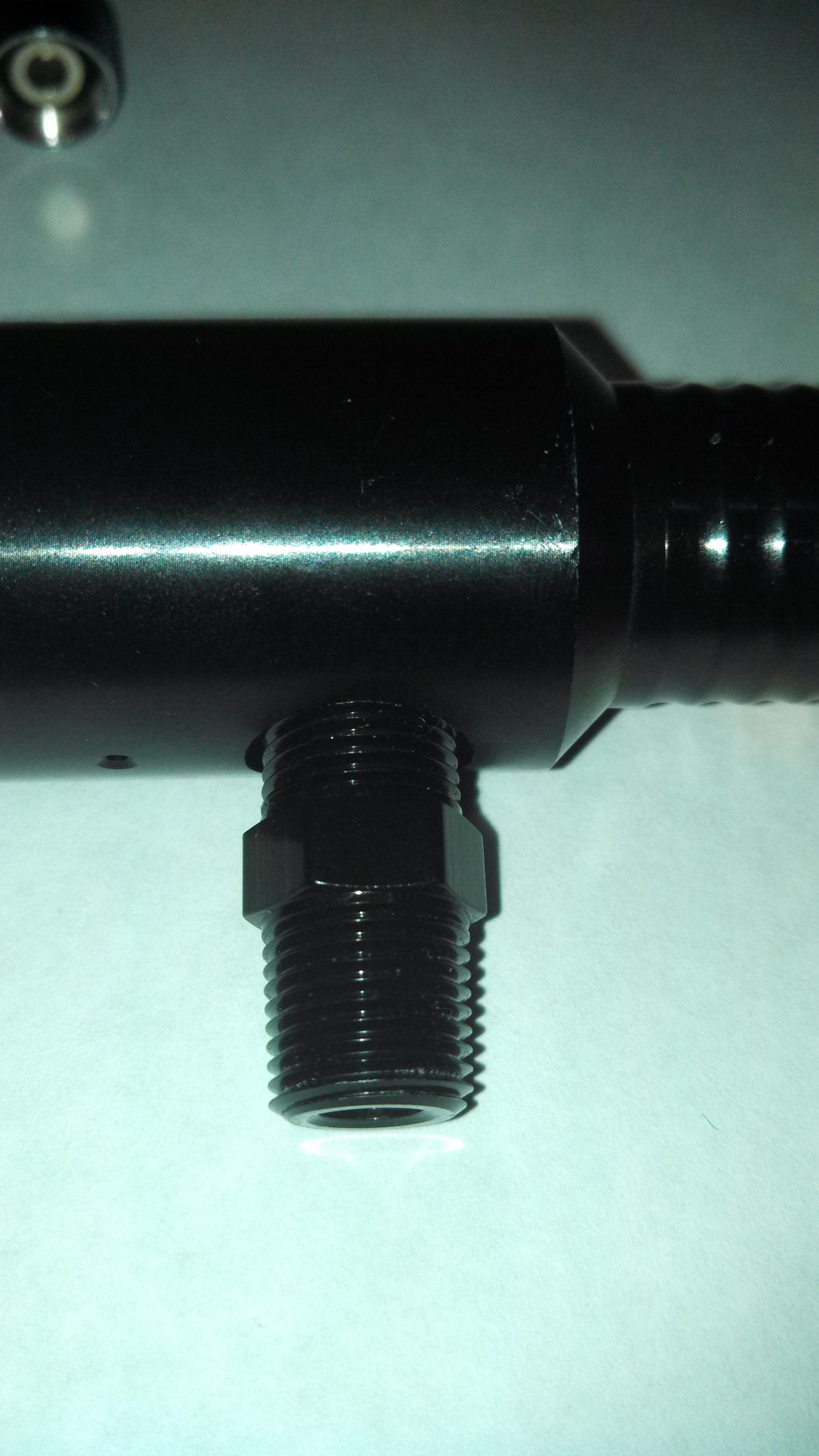 Here the NPT fitting is screwed into the 1/4 inch female NPT