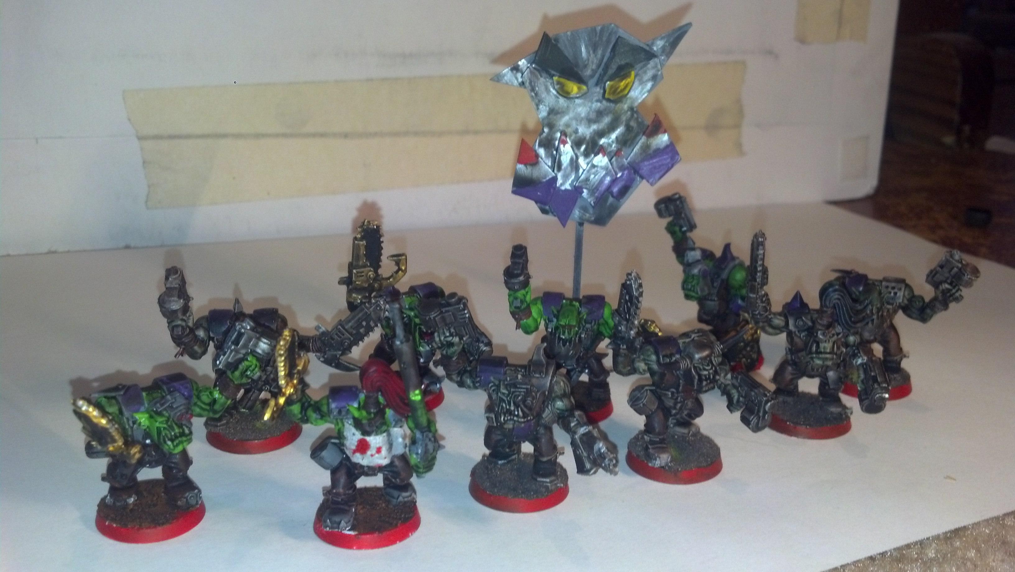 Nobz squad with bitbashed powerclawz, painboy with scratch built 'urty syringe, and nob with scratch built waaagh! banner