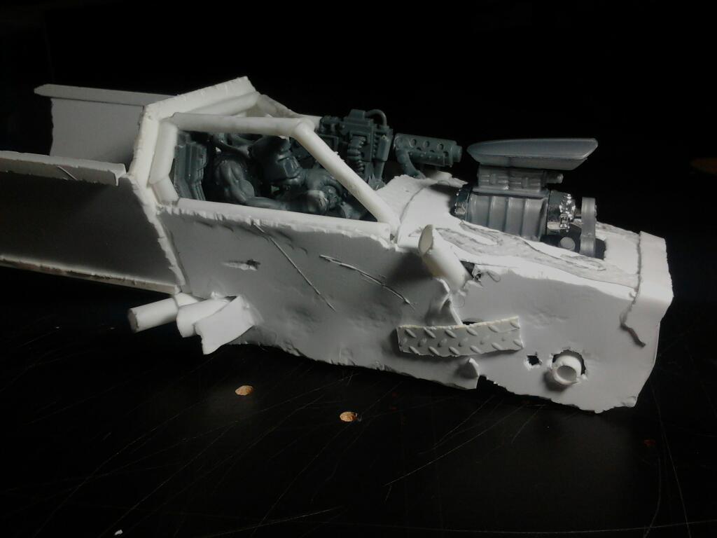 The right side panelling, you can see all the dents, scrapes and patching, as well as some more protruding exhaust pipes and the hole for the front axle