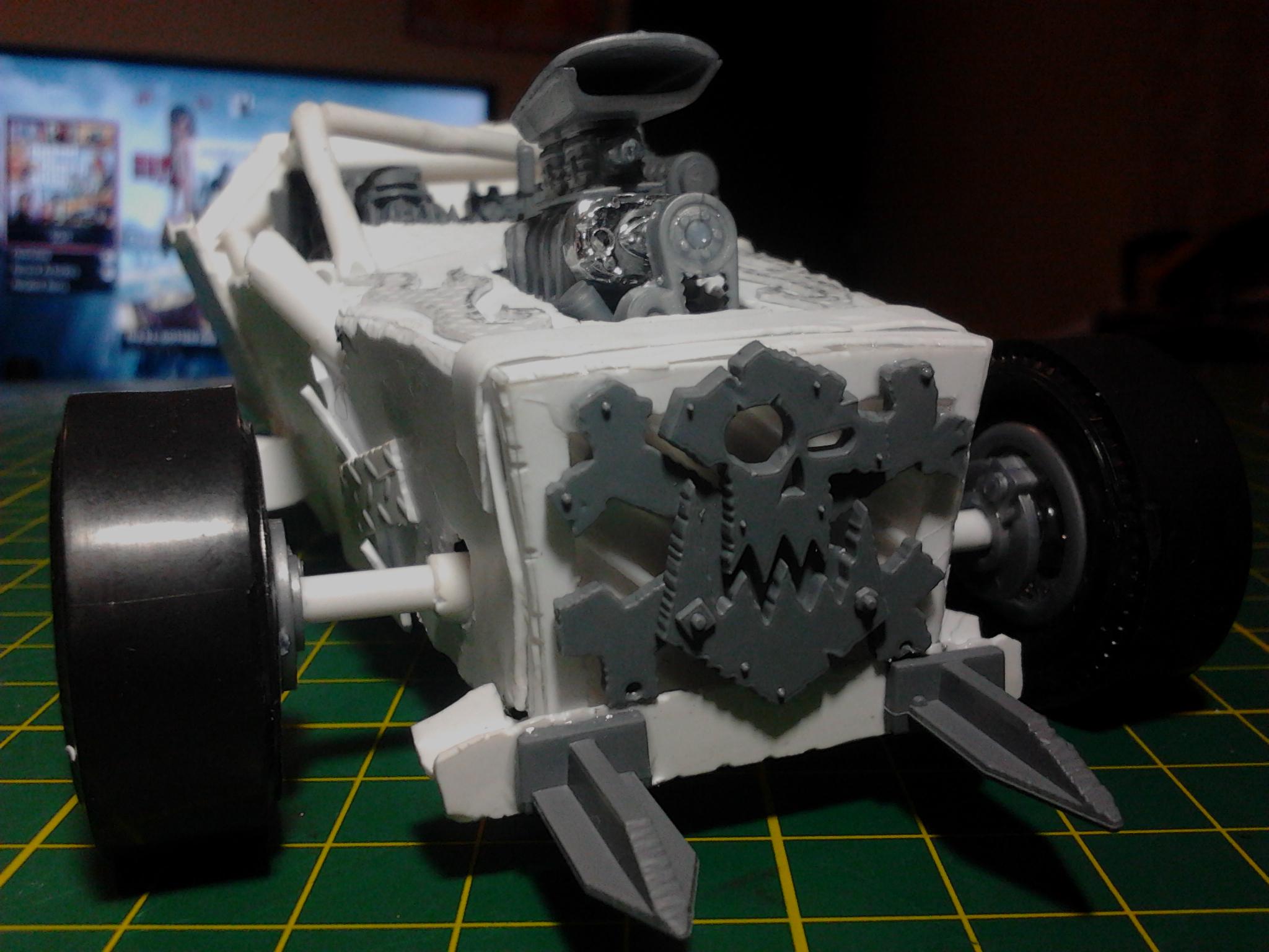 The glyph is mounted over a slanted grill that I built as a 3D box with slats and everything... All covered up. A ram for rammin and a rough fit of the wheels