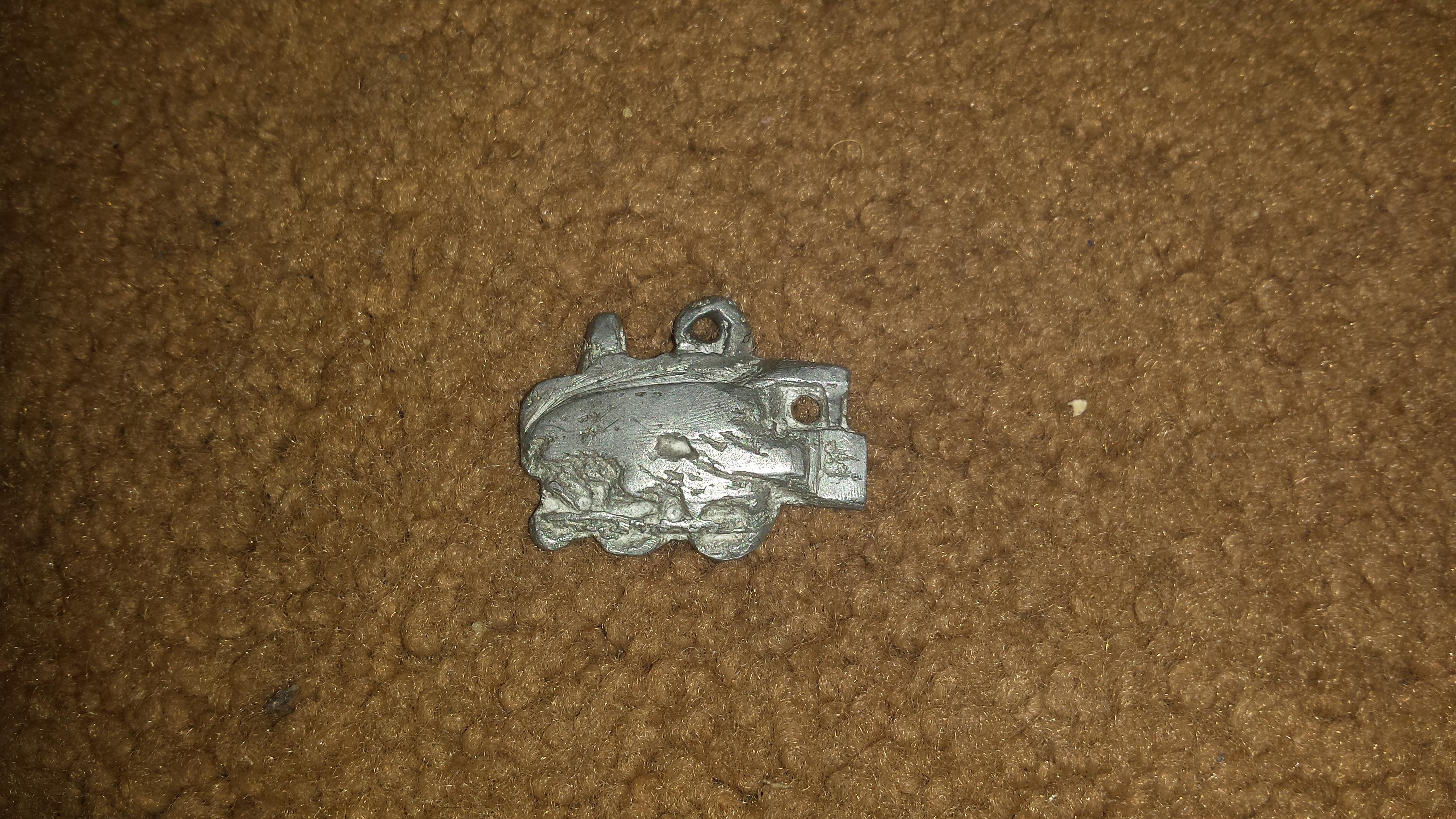 train pendant cast in a metal which may or may not be silver