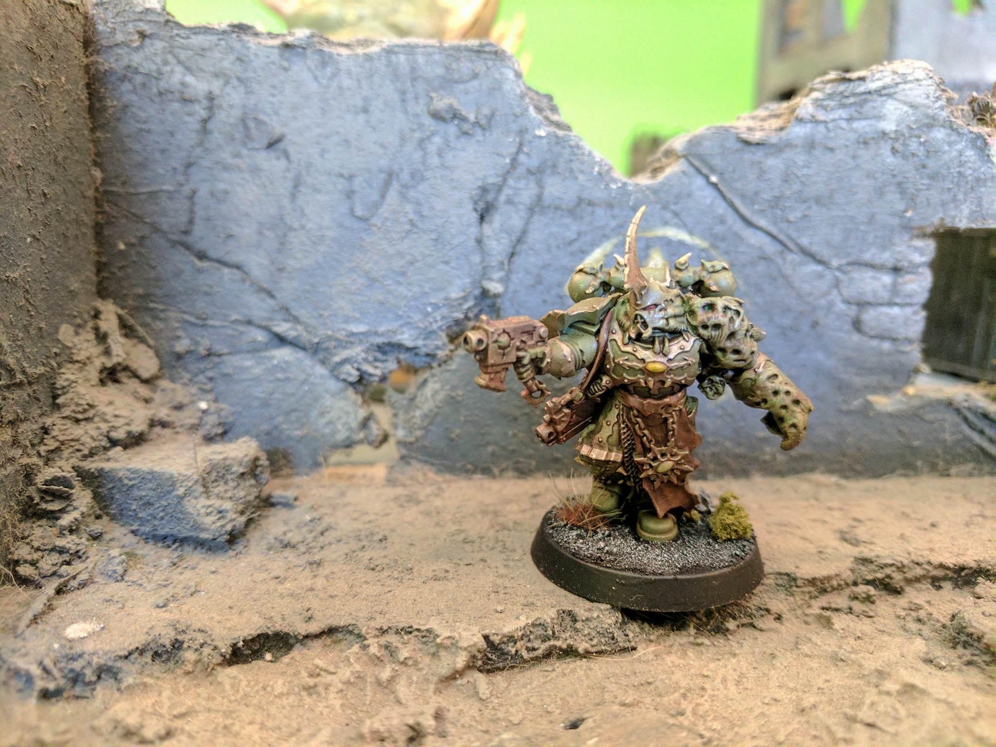 Lost part of his arm, replaced by shoddy green stuff work