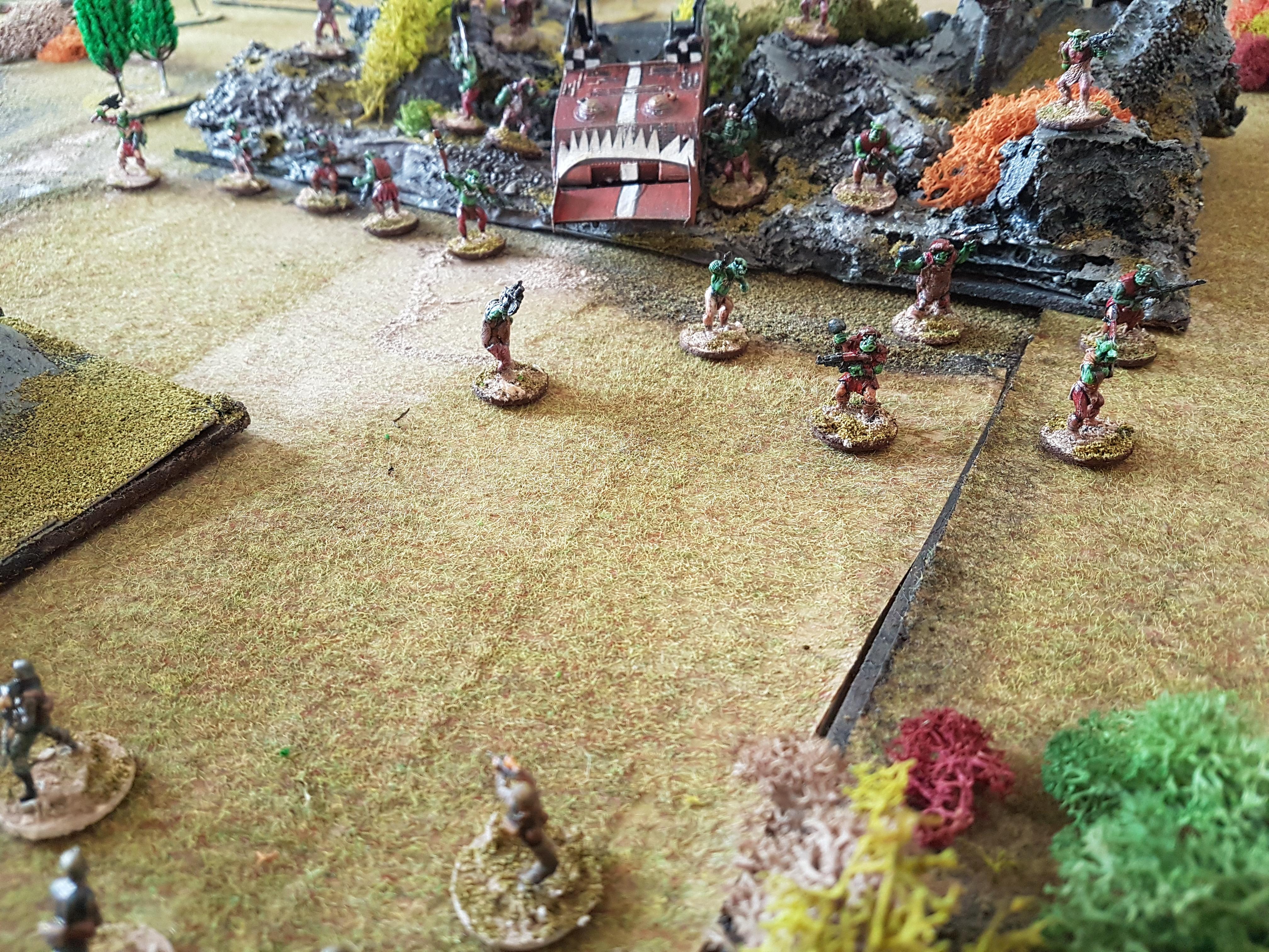 Imperial Guard come upon a stranded Ork mob with broken down Battlewagon