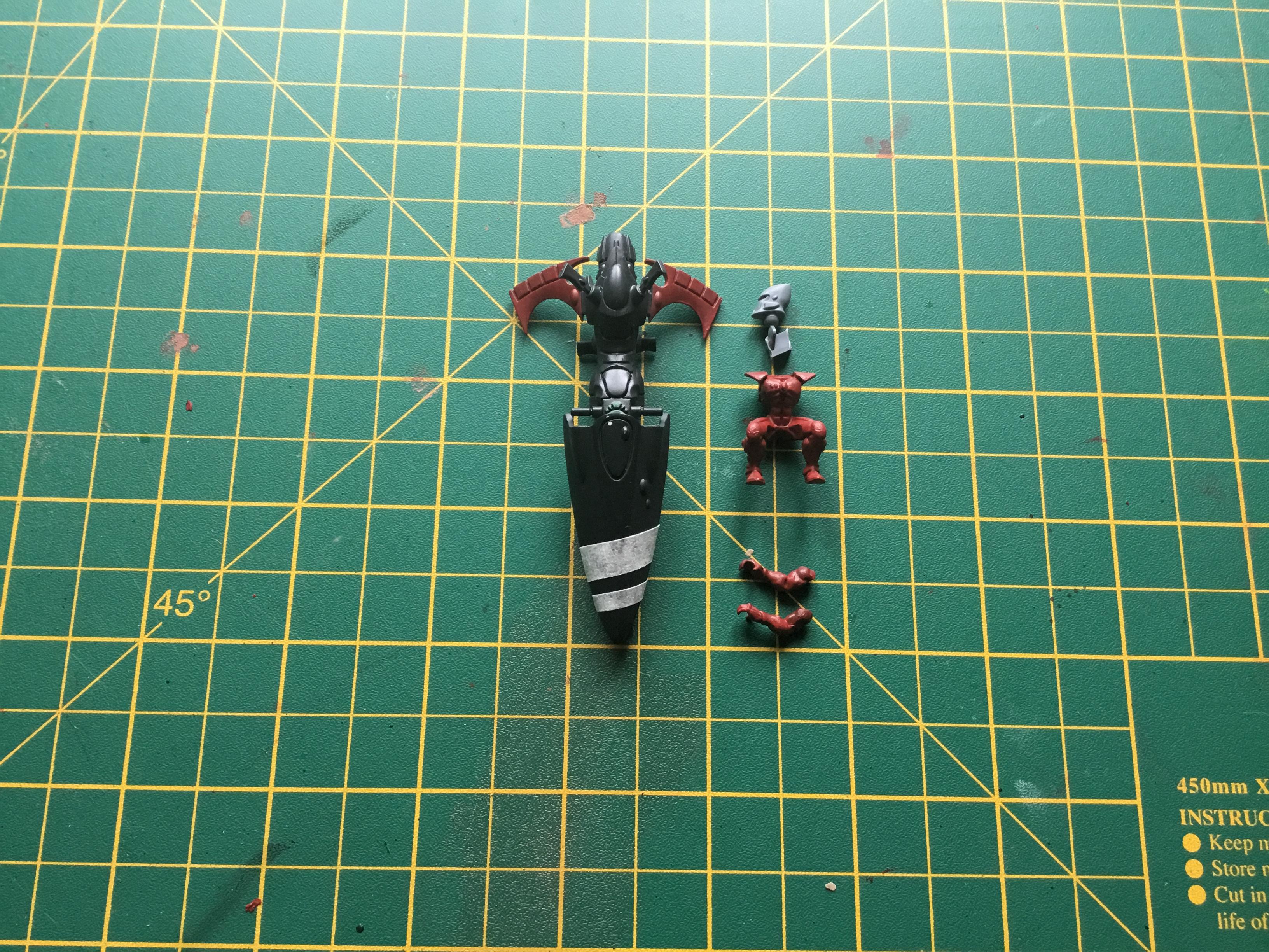 Using Mephiston Red I put the first layer on the rear wings and set the masking tape where I wanted the stripes to be