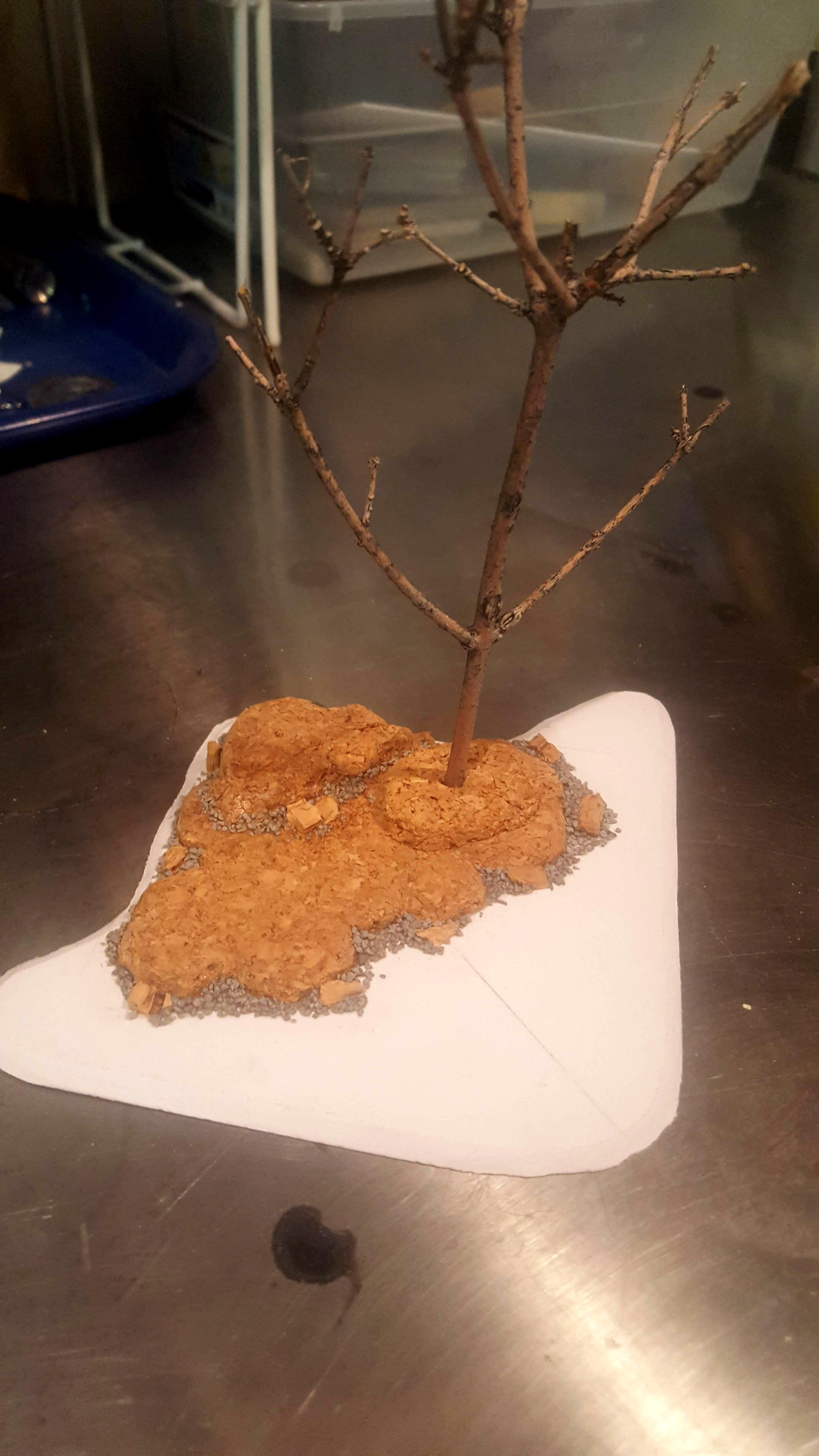 Prototype with foamed PVC base, cork rocks, railroad ballast, and a twig from the yard