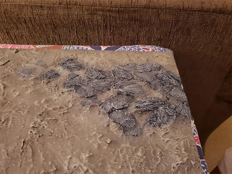 Rock outcropping painted and blended back into the ground color