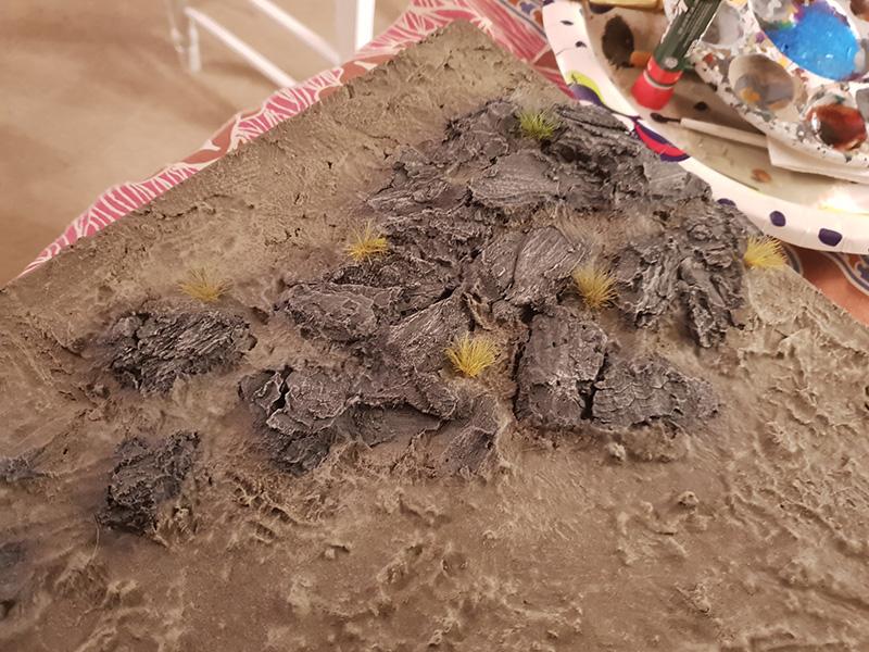 Grass tufts added to the rock outdrop