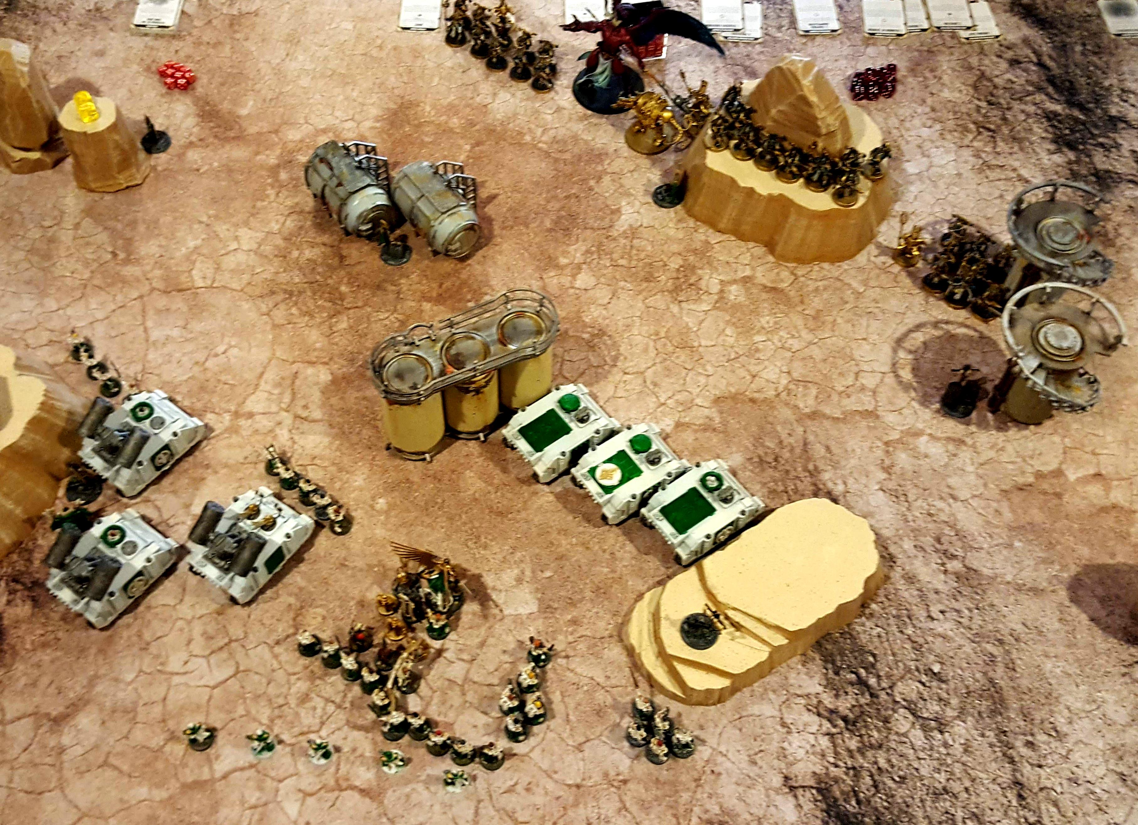 The initial deployment after the Vanguard move. Their three parking spots are outlined by infantry in the deployment zone. That infantry proceded to Advance and embark before the transports moved again in Turn 1