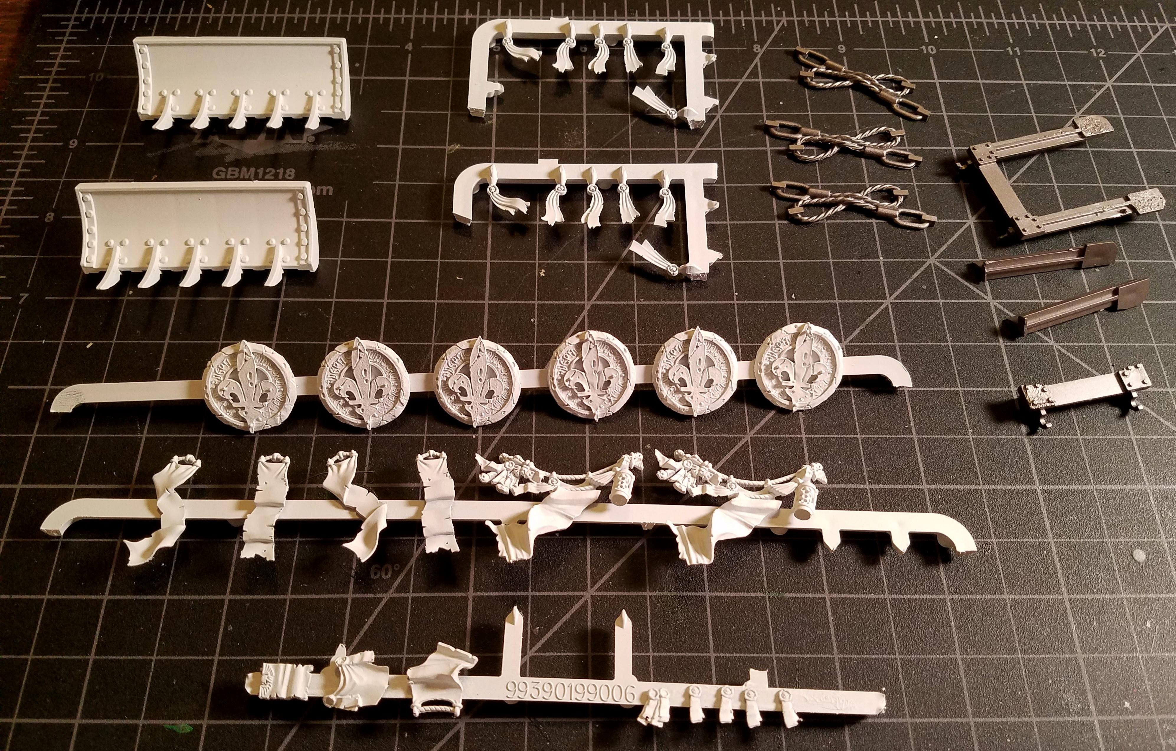 Lots of assorted tank trim, mounted on painting jigs and primed white with 2X