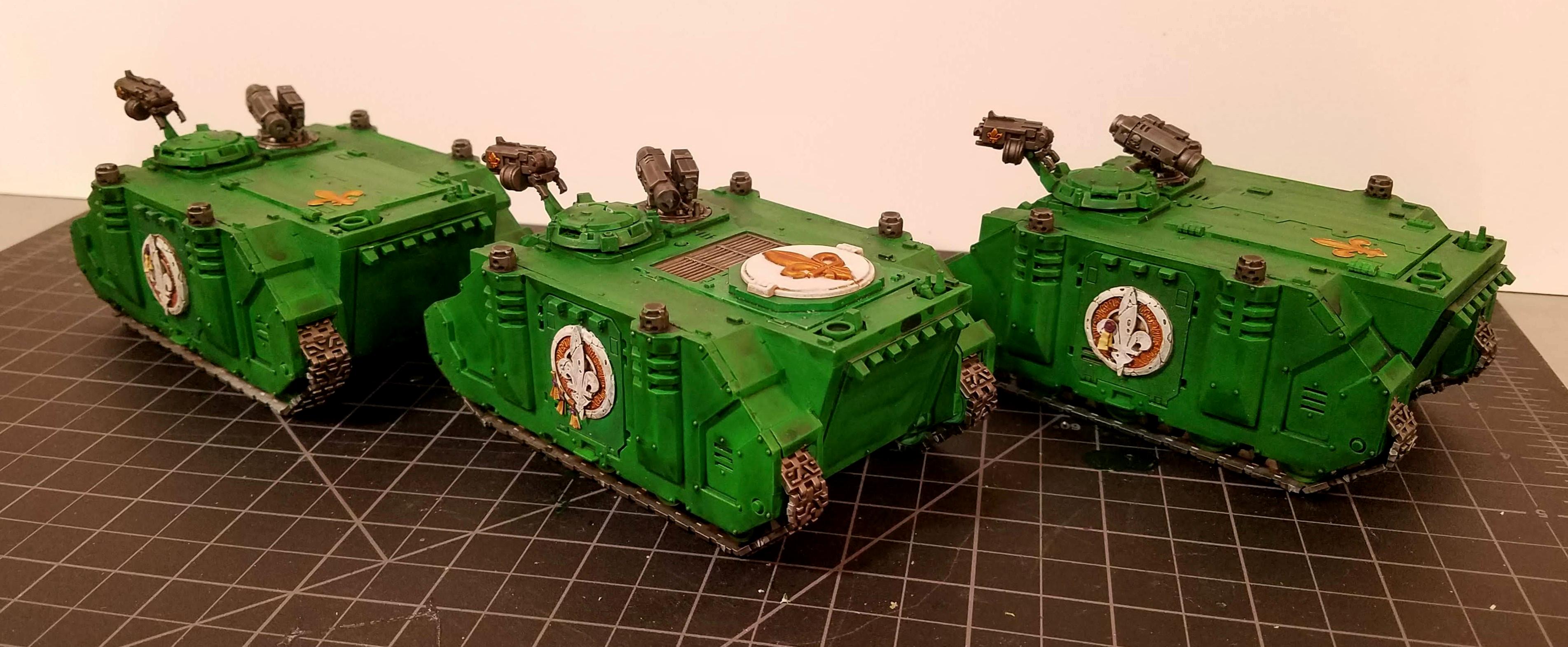 Three Adeptas Sororitas Rhinos, left