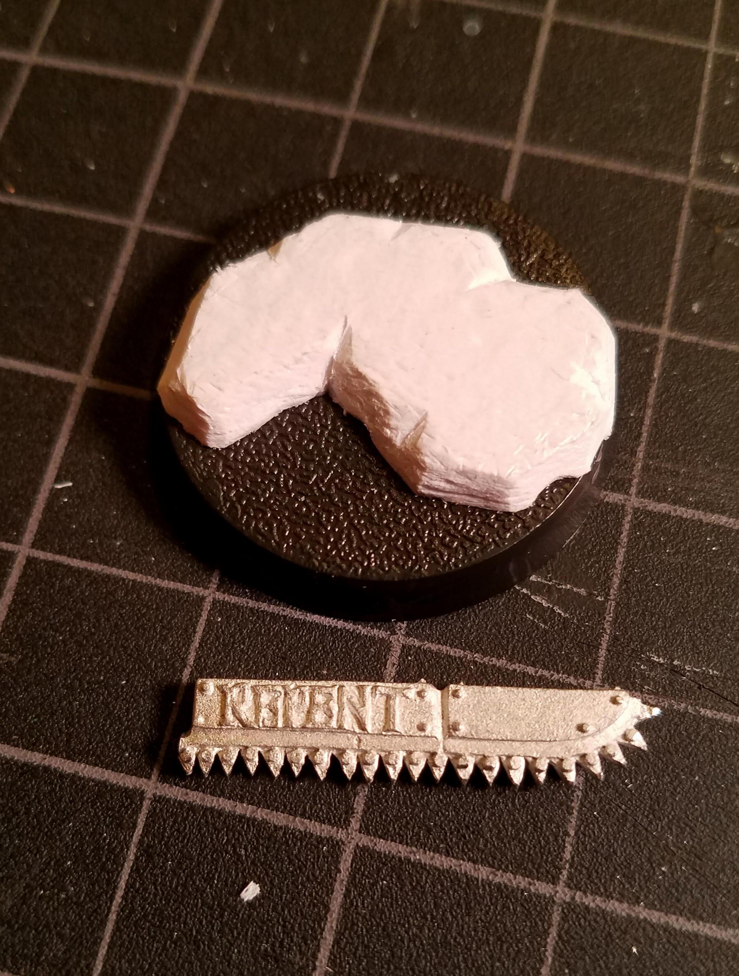 I cleaned up the chainsword and built a riser on the base of styrene card