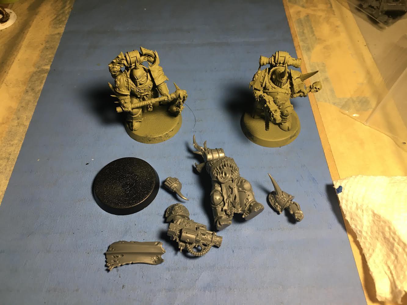 Three Plague Marines, 2 primed Death Guard Green (One w/ Flail, one w/ Bolter) and one unassembled w/ Blight Launcher
