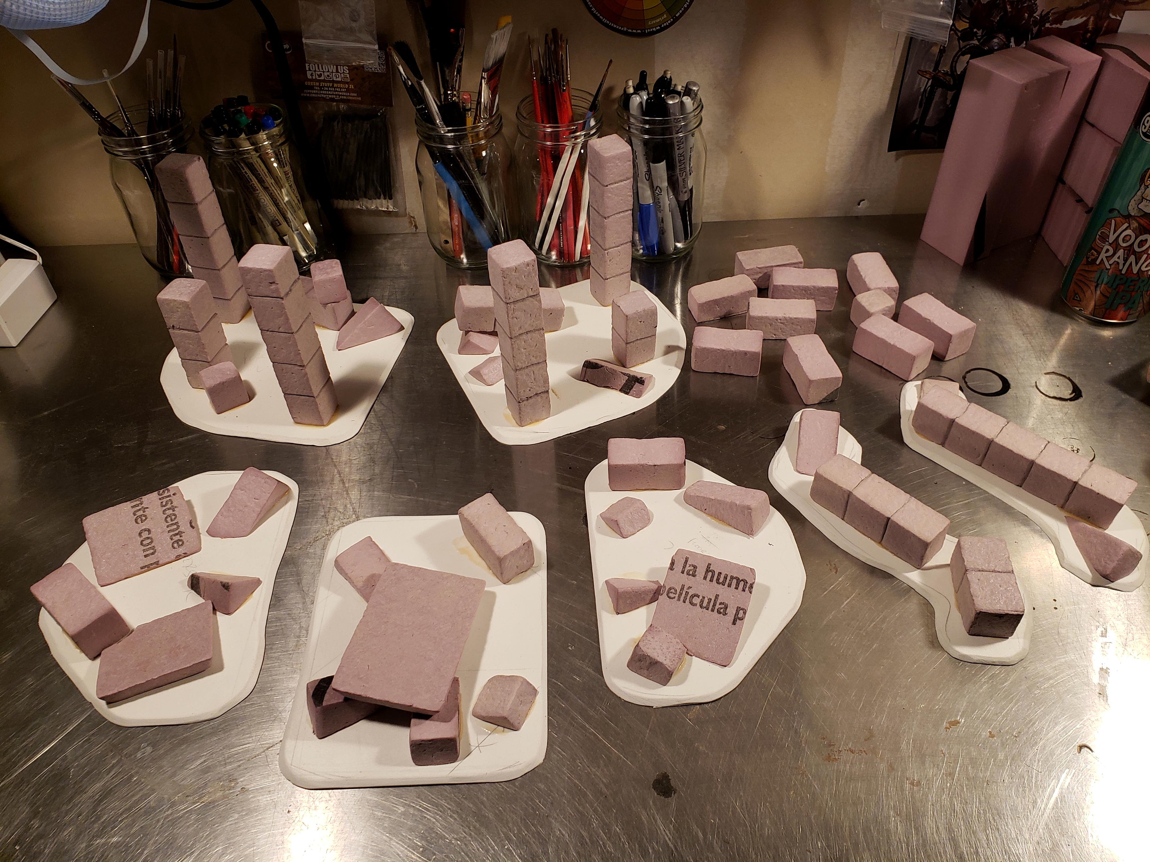 Clockwise from top left: two &quot;forests&quot;, some scatter terrain, two &quot;barricades&quot;, and three &quot;craters&quot;, all headed for paint to match the arches
