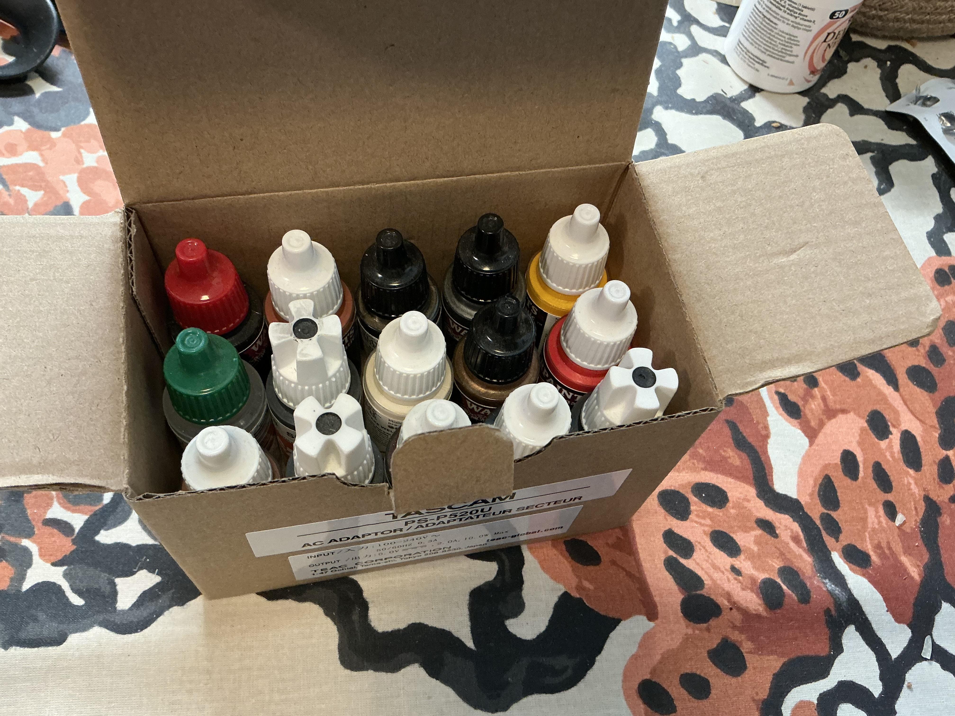 An old cardboard box was perfectly sized for paint storage!